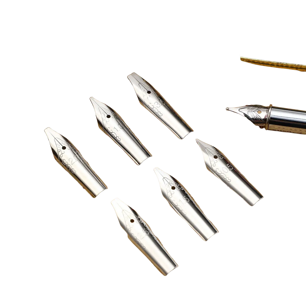 Silver stainless steel fountain pen nib set with intricate engravings displayed with black and gold fountain pen