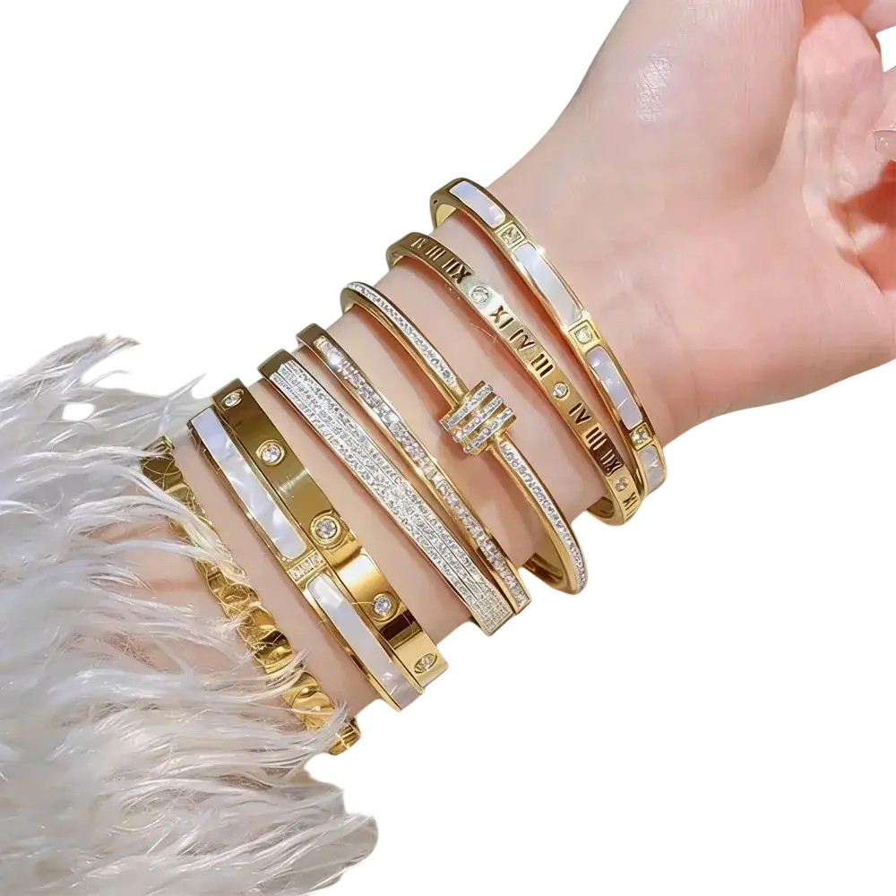 A collection of gold stainless steel bangle bracelets for women with roman numeral designs diamonds and mother-of-pearl accents