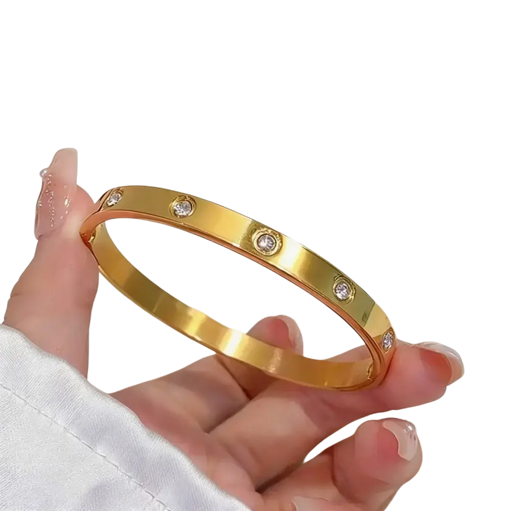 Gold-tone stainless steel bangle bracelet with five clear gemstones and roman numeral design for women