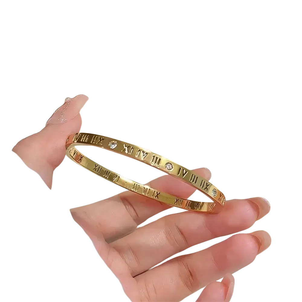 Stainless steel gold-toned bangle bracelet with engraved roman numerals and small embedded diamonds for women