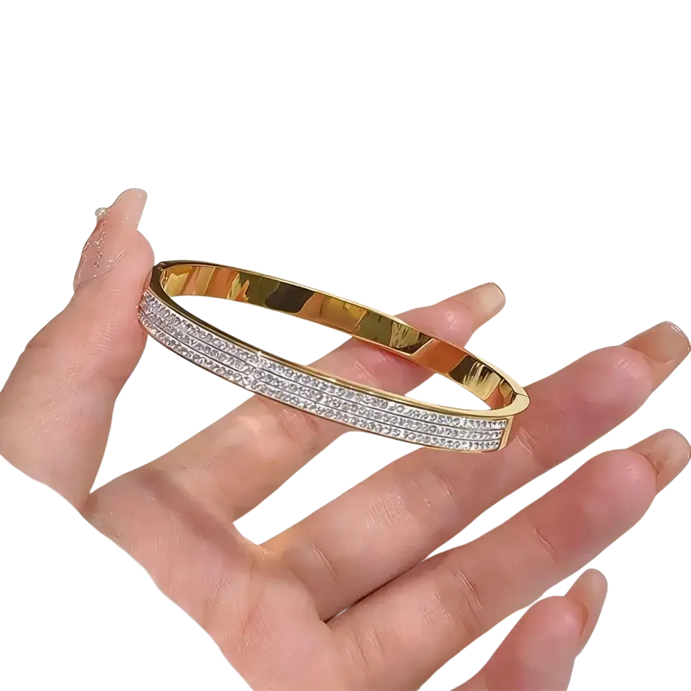 Gold-toned stainless steel bangle bracelet for women adorned with three rows of clear sparkling crystals