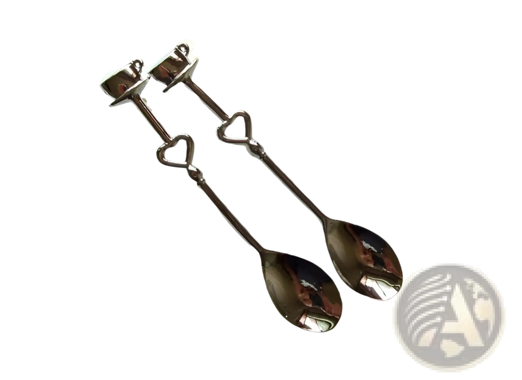 A pair of dark-finished stainless steel coffee spoons with heart-shaped handles and decorative tops in a gift set