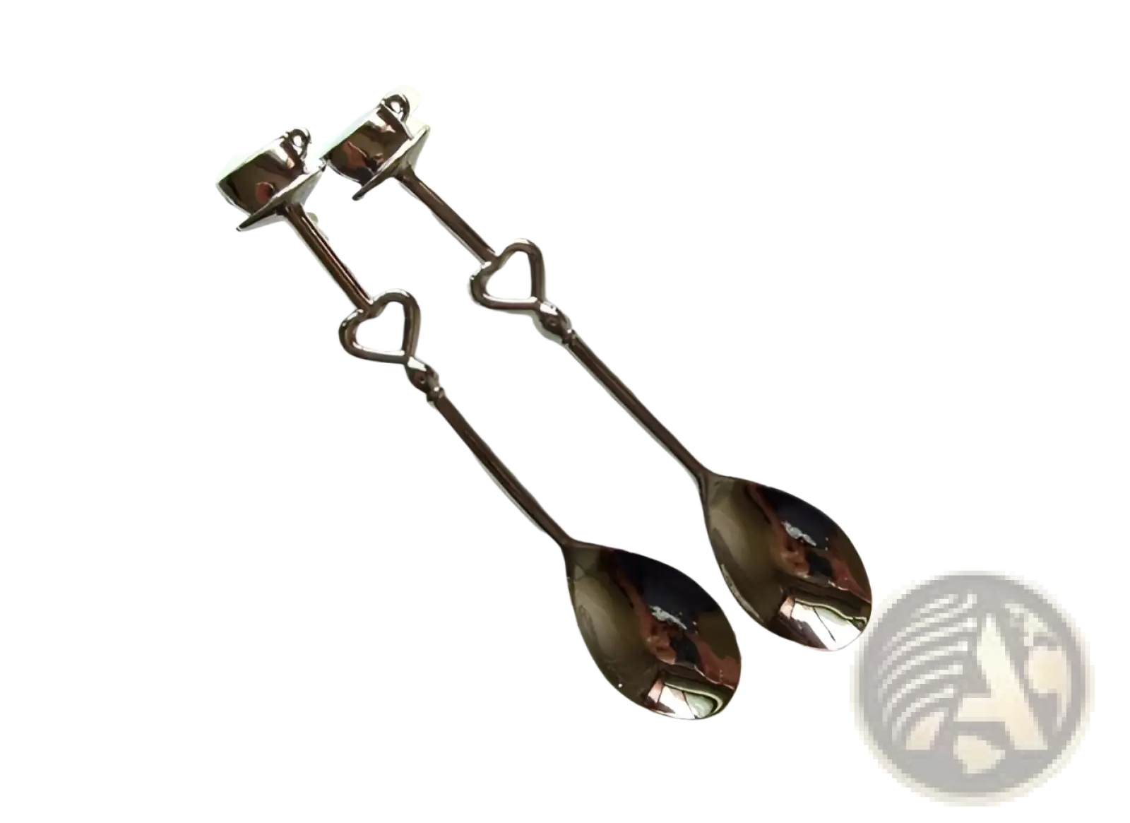 A pair of dark-finished stainless steel coffee spoons with heart-shaped handles and decorative tops in a gift set