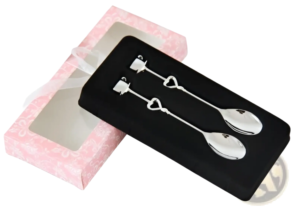 A pair of silver stainless steel heart-shaped coffee spoon charms with polished handles and rounded bowls
