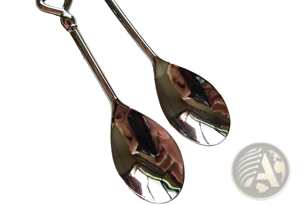 Shiny silver stainless steel heart coffee spoons with long slender handles and reflective bowls in a gift set