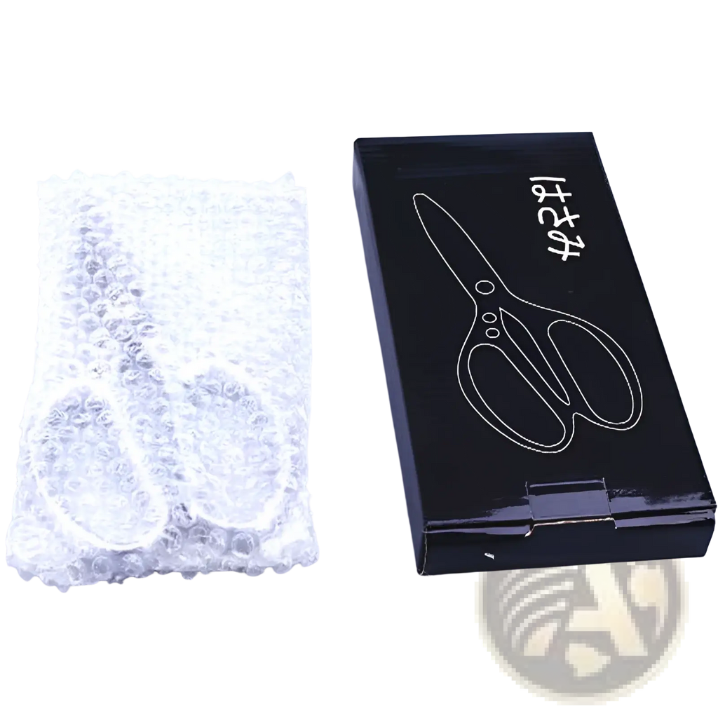 A sleek black box with scissors illustration next to silver-toned stainless steel kitchen shears for meat and seafood wrapped in bubble wrap