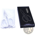 A sleek black box with scissors illustration next to silver-toned stainless steel kitchen shears for meat and seafood wrapped in bubble wrap