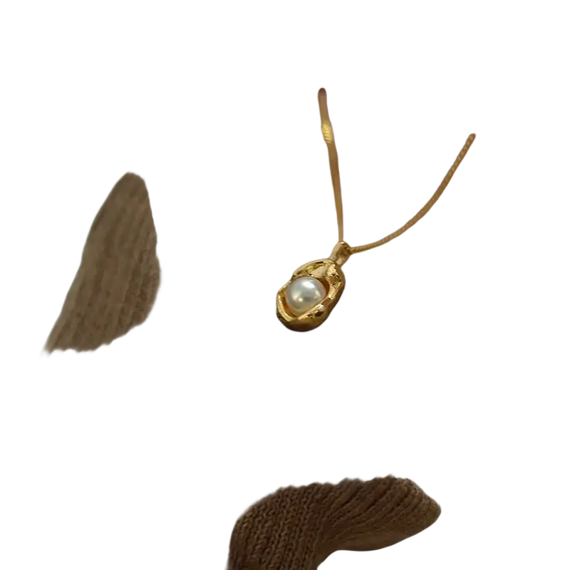 Delicate gold stainless steel necklace for women girls with a single pearl in an ornate golden setting