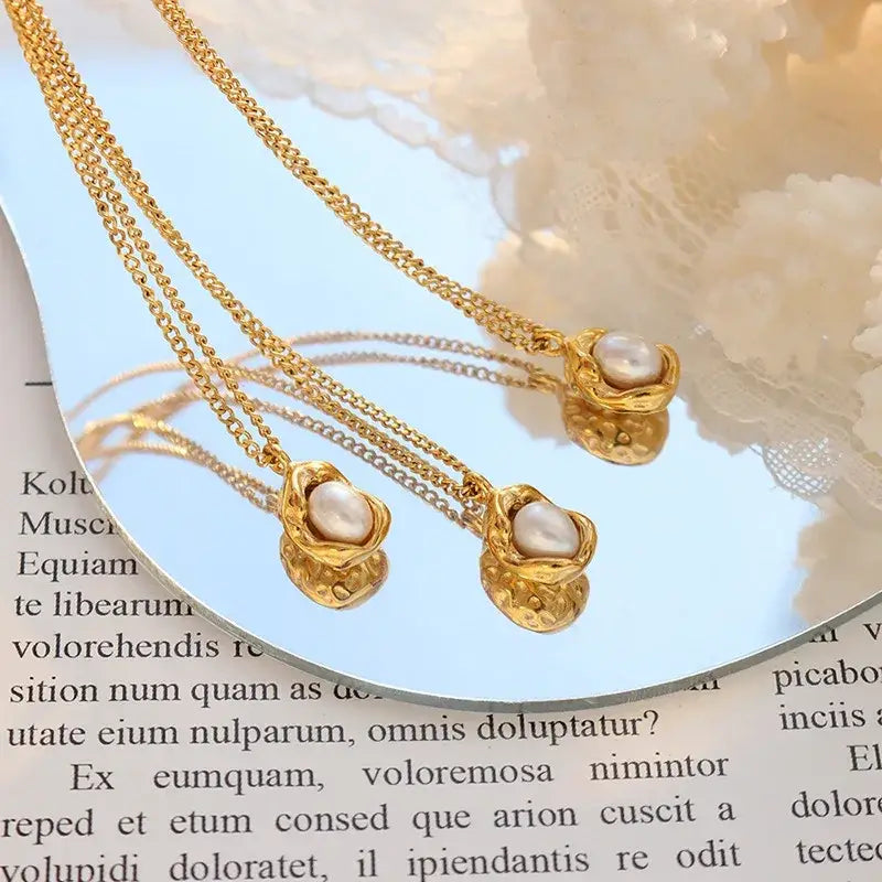 Gold-toned stainless steel pearl pendant necklace for women girls with delicate chain and textured shell-like pendant