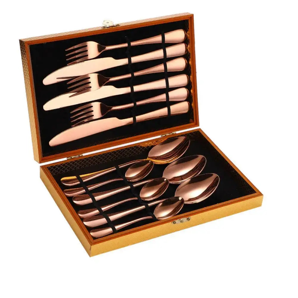 Premium stainless steel steak cutlery set with rose gold finish neatly arranged in a wooden presentation box
