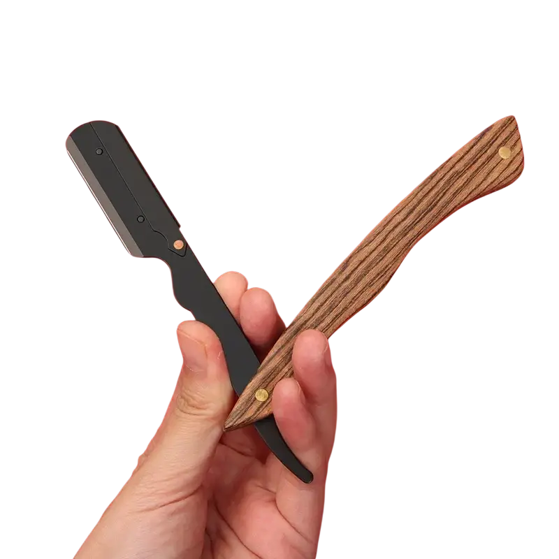 A stainless steel straight razor with a wood handle and polished blade held against a vibrant red background