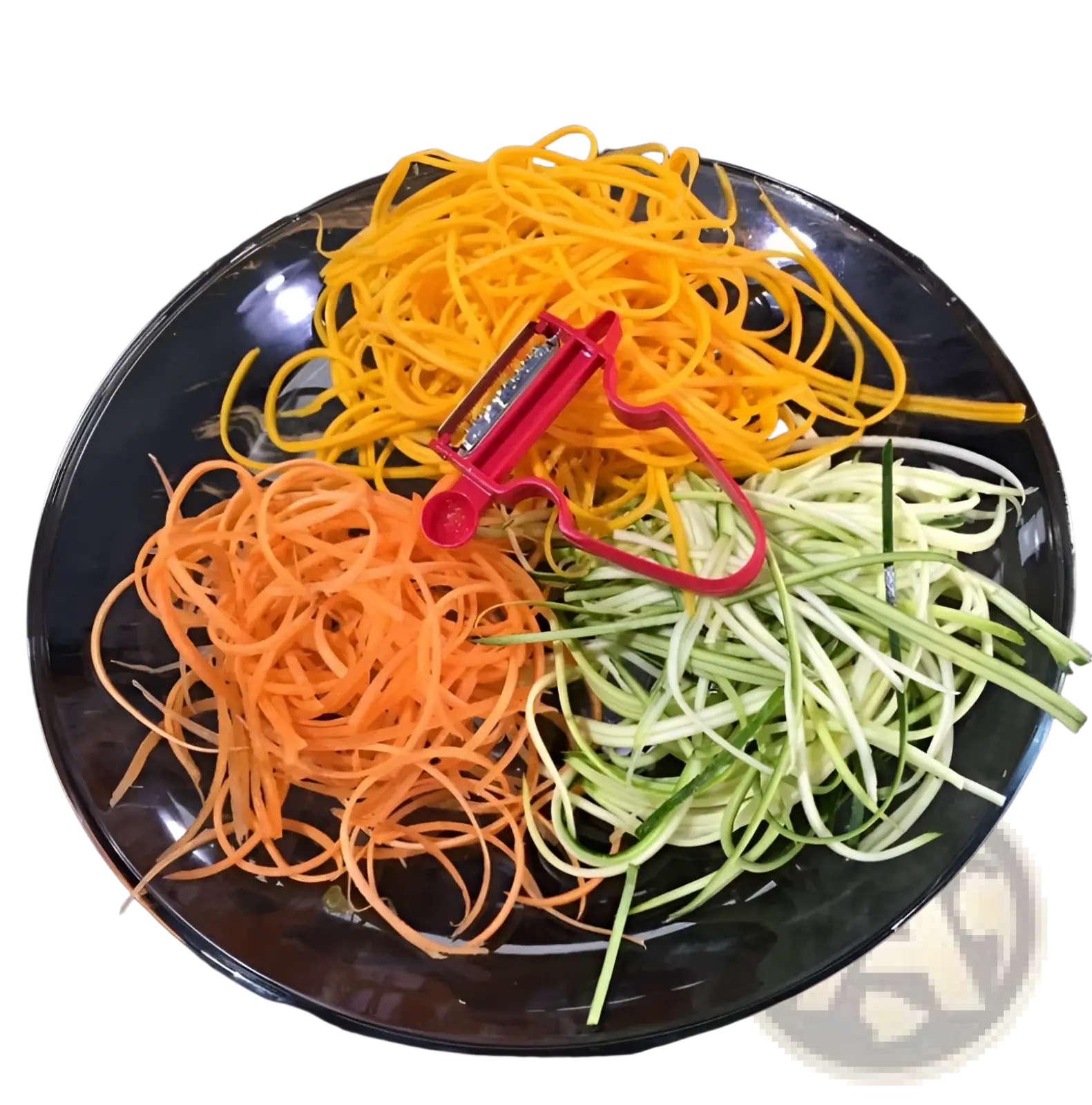 A red stainless steel vegetable peeler rests on spiralized orange yellow and green vegetables on a glass plate