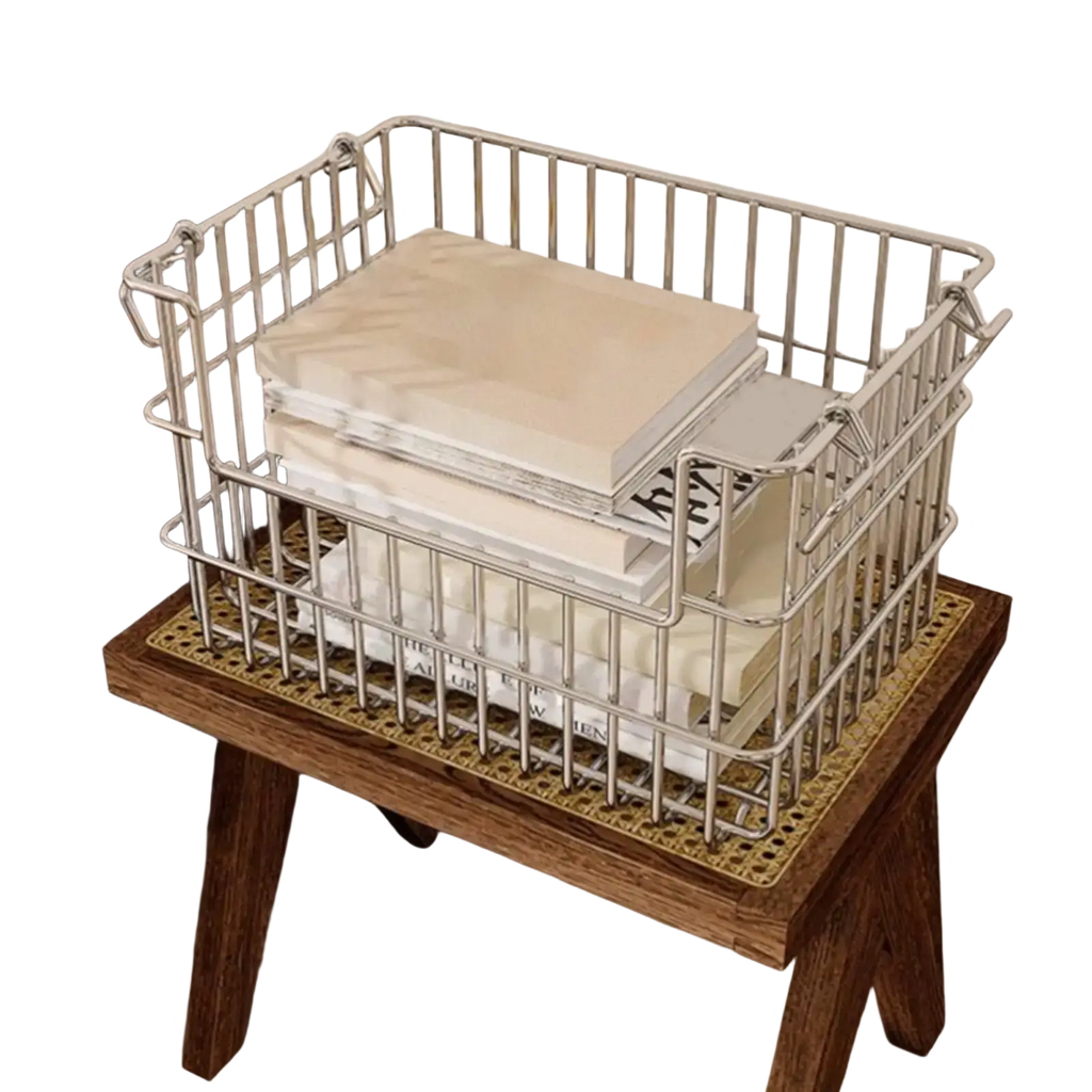 Stainless steel silver wire mesh storage basket with rectangular shape and reinforced handles holding stacked books
