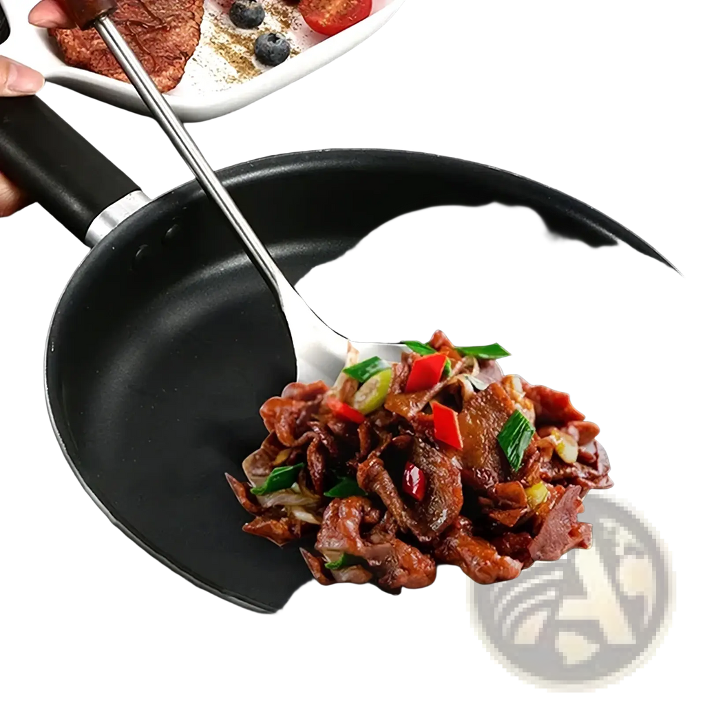 Black non-stick frying pan with silver rim containing cooked meat and vegetables alongside stainless steel wok spatula set
