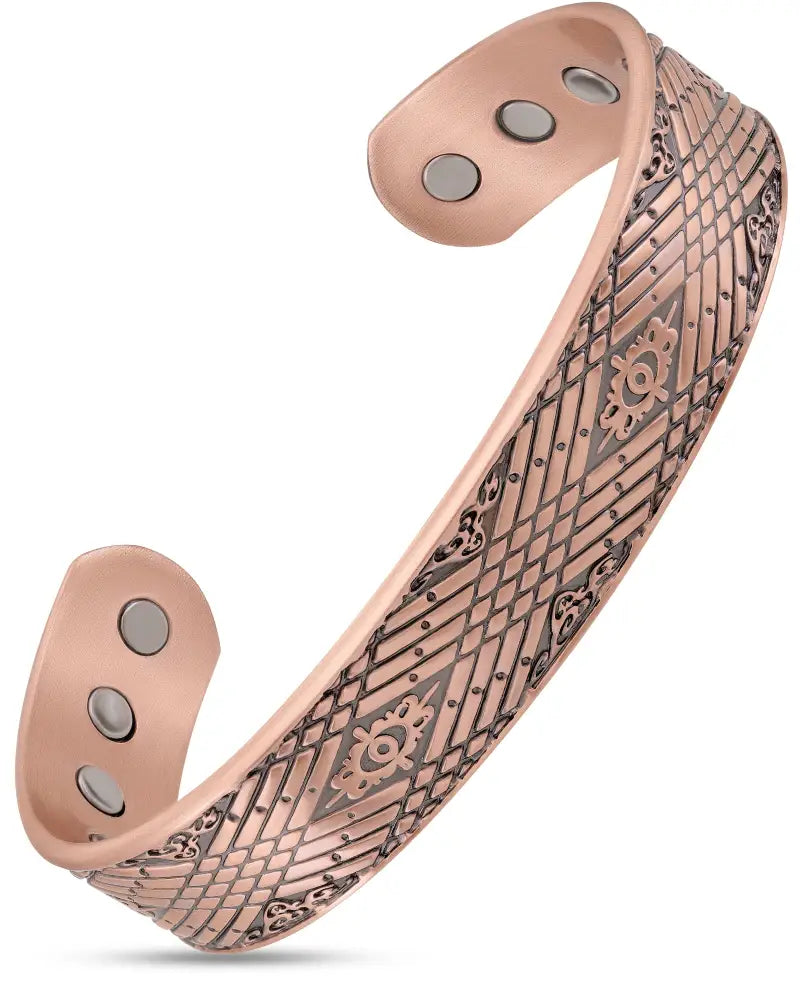 Stamped Celtic Mist magnetic copper cuff bracelet in rose gold tone with intricate geometric and floral engravings