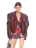 A glossy burgundy leather moto jacket with a stand collar and zipper closure for stylish outerwear