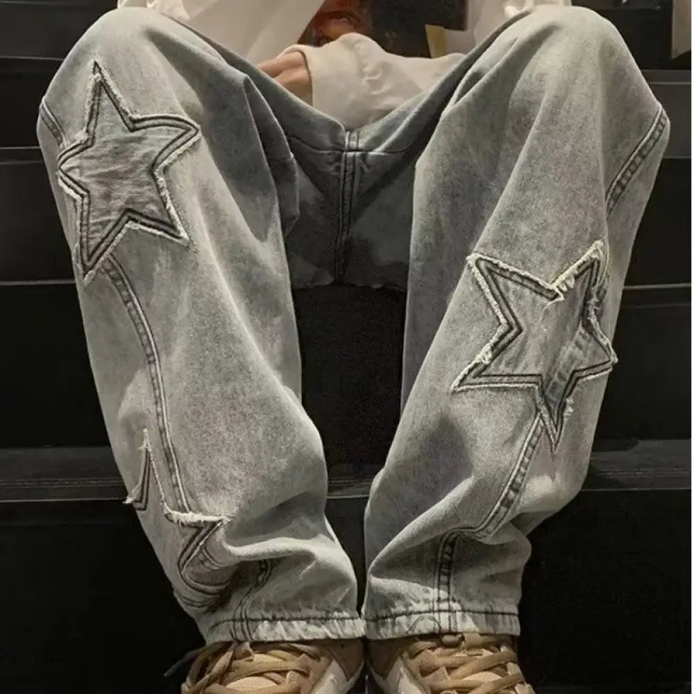 Men’s y2k light-wash denim baggy streetwear jeans with prominent distressed star applique patches on each thigh