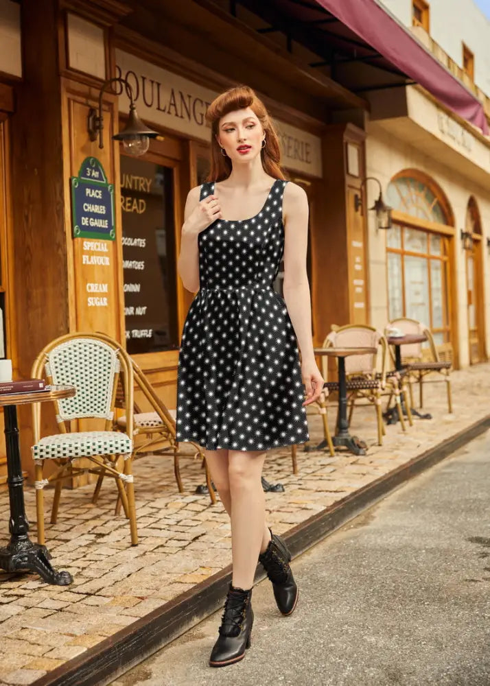 Black sleeveless starburst retro cotton fit and flare dress with white polka dots square neckline and fitted waist