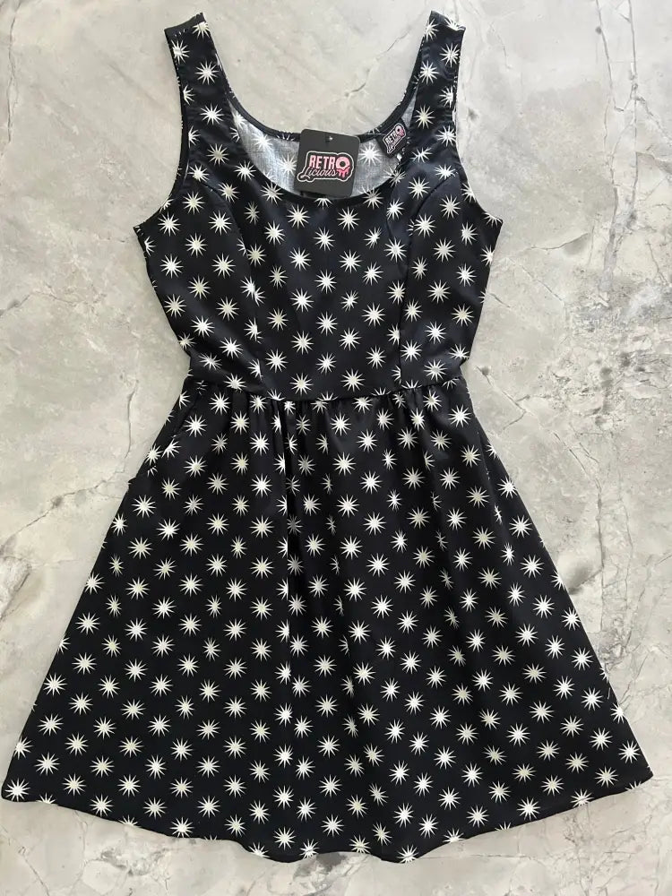 Black sleeveless starburst retro cotton fit and flare dress with fitted bodice flared skirt and pockets