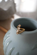 A delicate gold 18k pvd stainless steel zirconia toe ring set with three teardrop-shaped clear stones in an open design