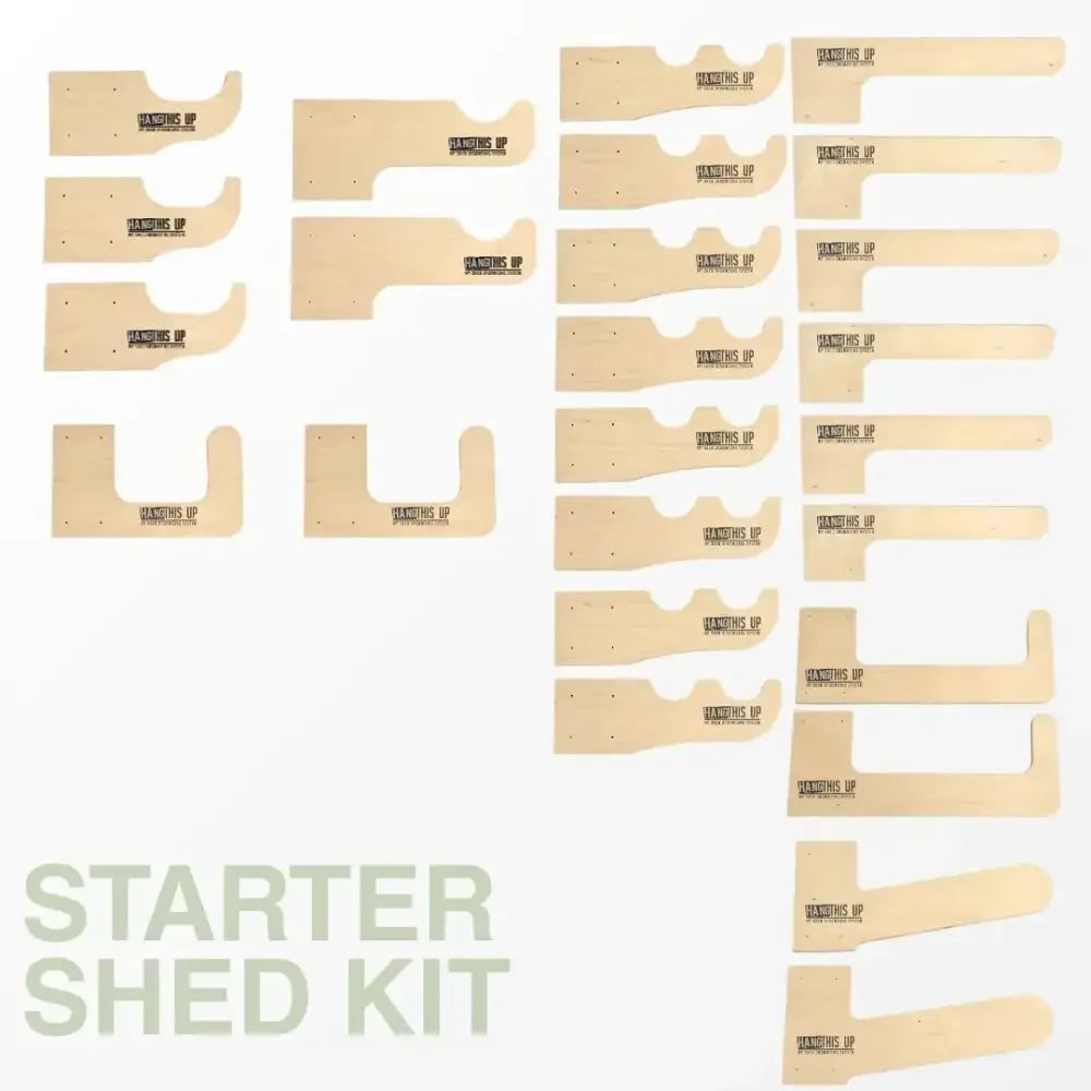 Light-colored wooden hanging shelf supports from a starter shed kit for stud mount garden tool organizer system