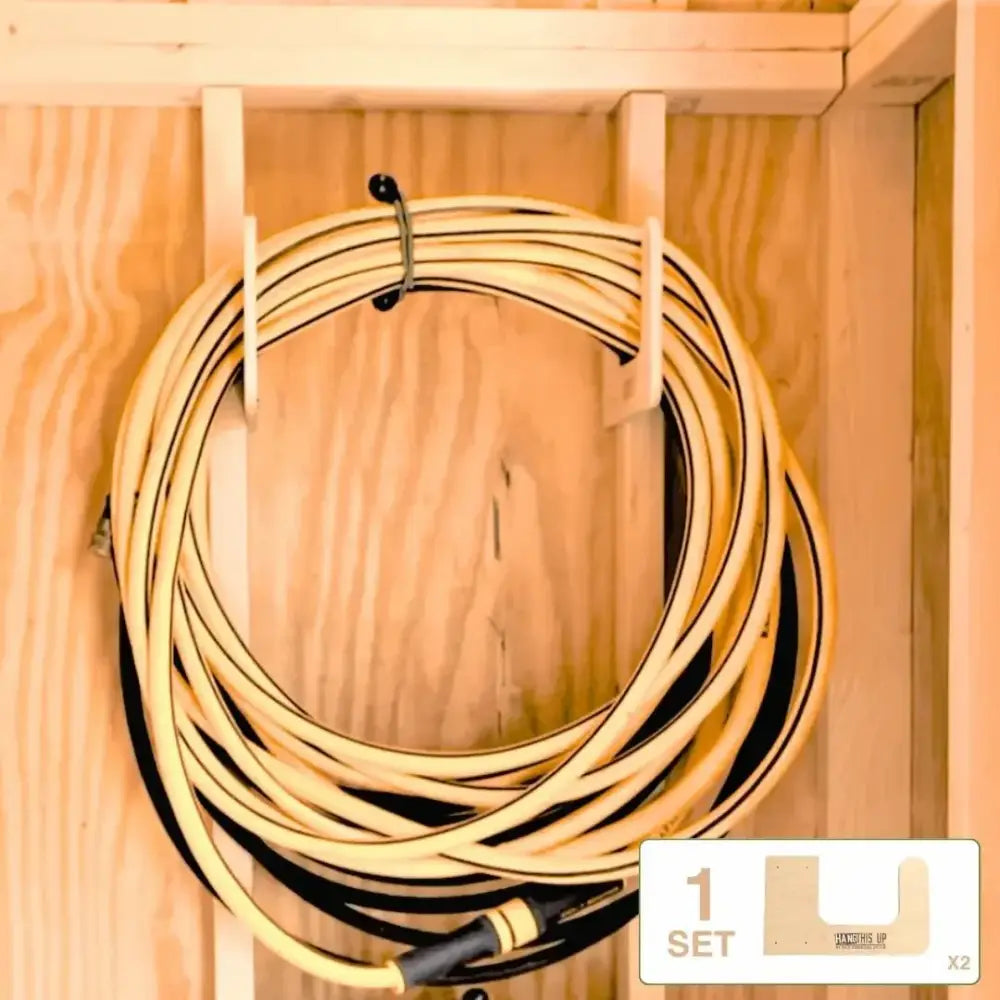 A coiled yellow and black garden hose neatly stored on a wooden rack in a starter shed kit stud mount organizer system