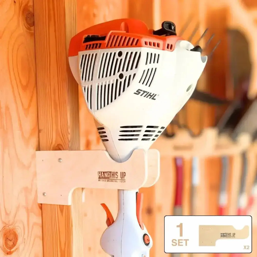 White and orange stihl string trimmer mounted on wooden wall holder in starter shed kit stud mount garden tool organizer system