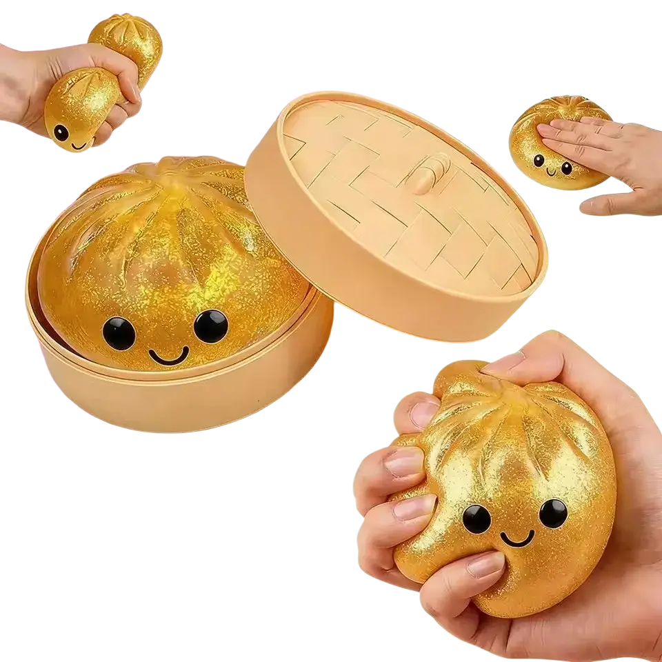 Golden glittery steamed bun squeezing toy with smiling face and elastic texture in a steamer container