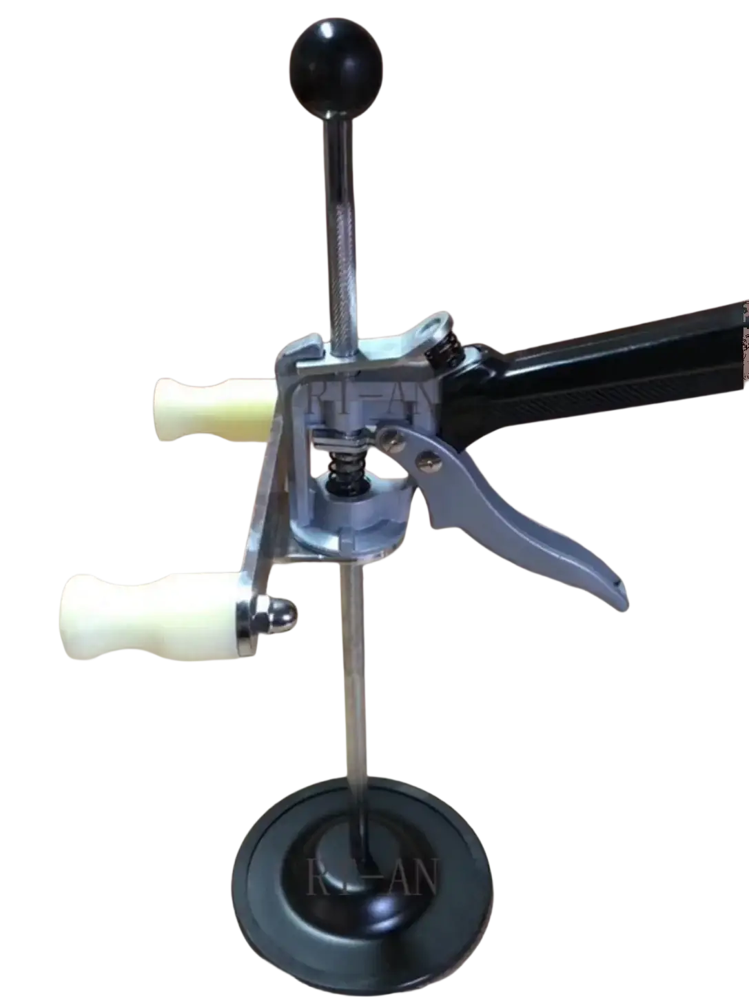 Black and silver metal bottle cap opener with black handle cream knobs and gray lever for steering wheel holder use