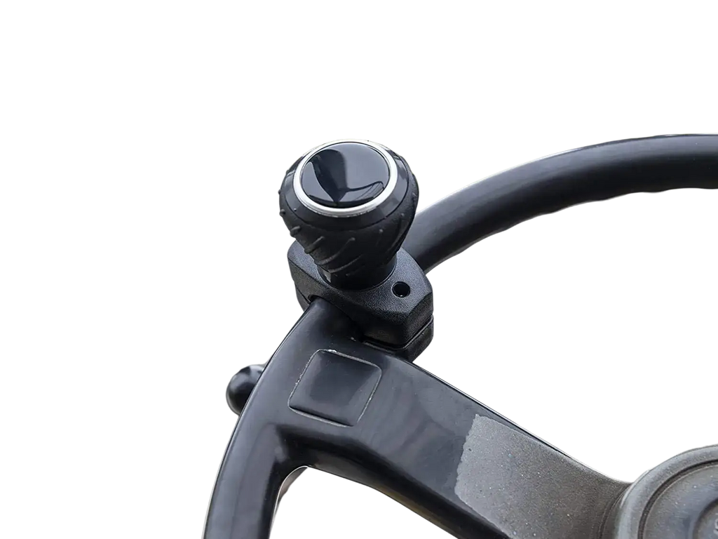 Black textured ergonomic steering wheel spinner knob with silver accent ring mounted on forklift steering column