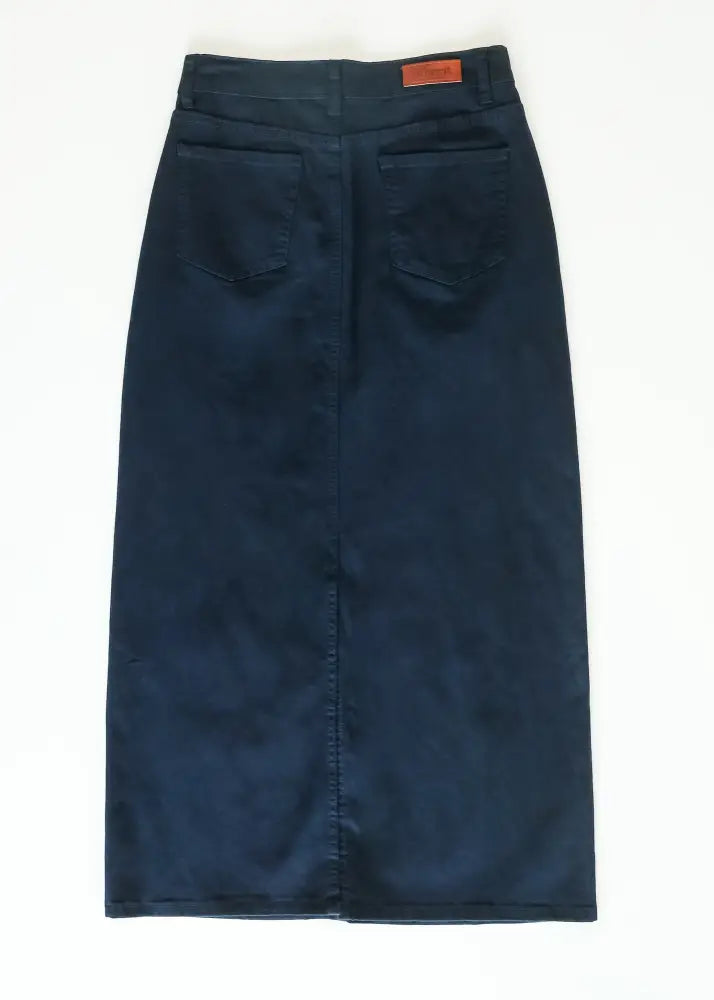 Dark blue denim midi skirt with brown leather brand patch at waistband from stella navy embroidered maxi denim skirt with back slit
