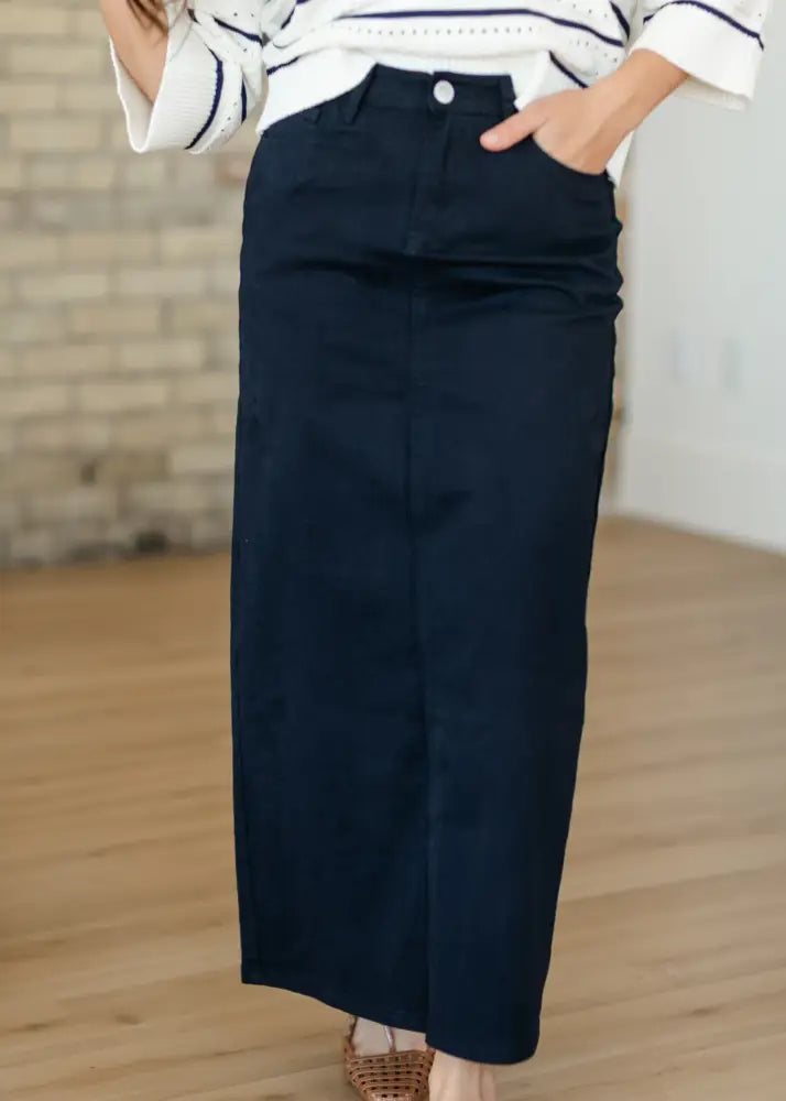 Navy blue high-waisted midi denim skirt with straight cut front seam detail and back slit by Stella
