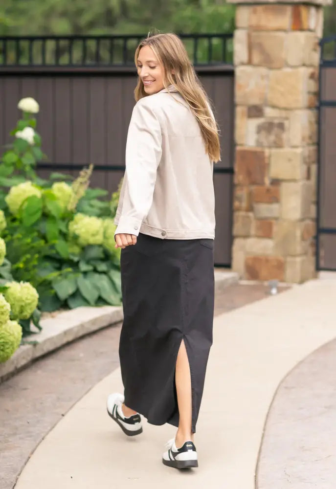 Beige denim jacket with classic collar and button closure paired with Stella Onyx Black high waisted denim maxi skirt