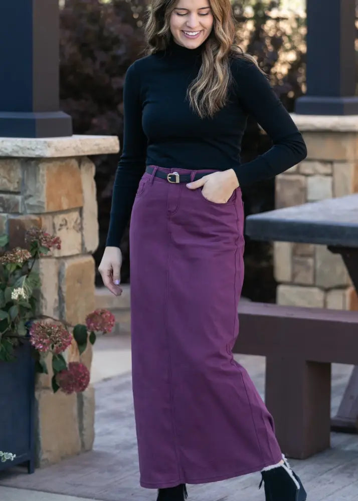 A long flowing purple denim maxi skirt with a fitted waistband and belt loops from Stella Orchid