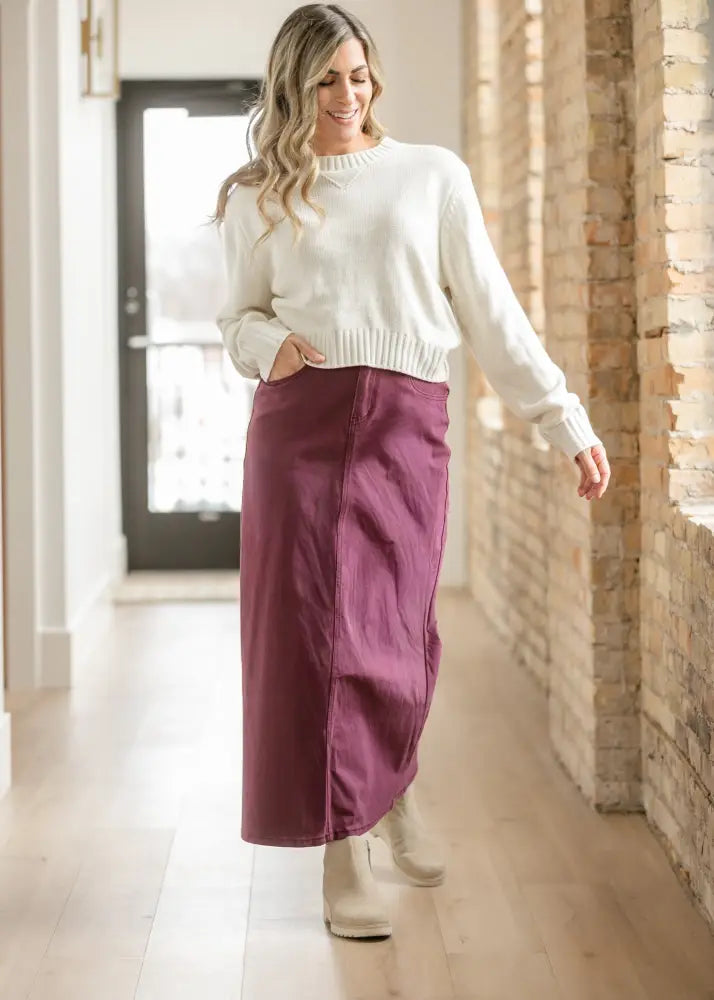 A flowing deep purple high waisted denim midi skirt with a front zipper detail from Stella Orchid