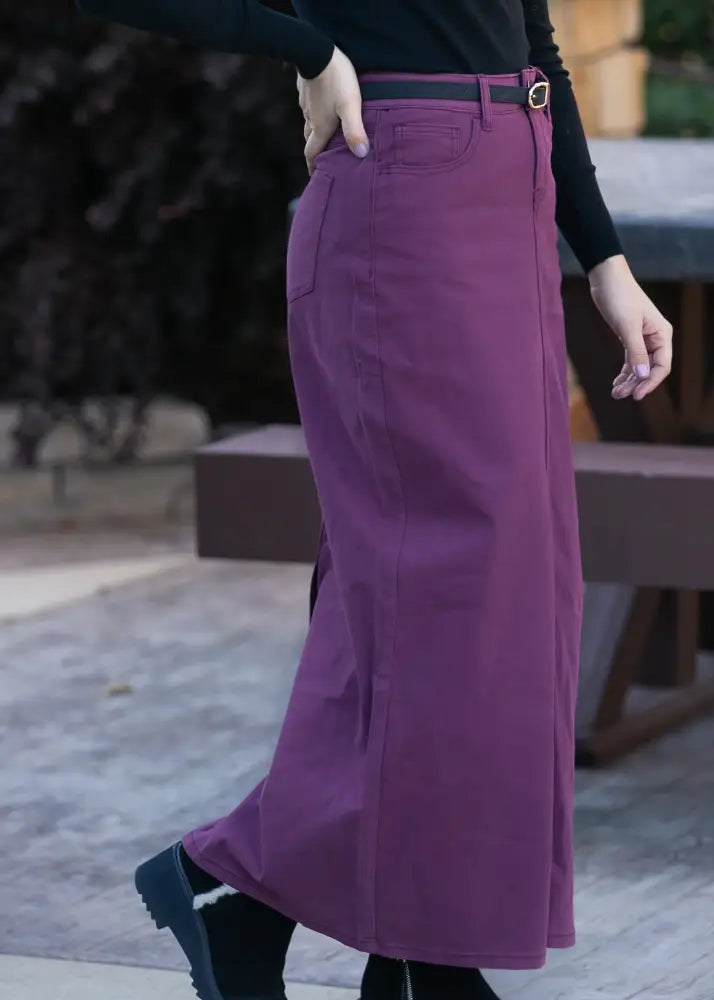 Stella Orchid high waisted purple denim maxi skirt with a straight cut, black belt, and silver buckle