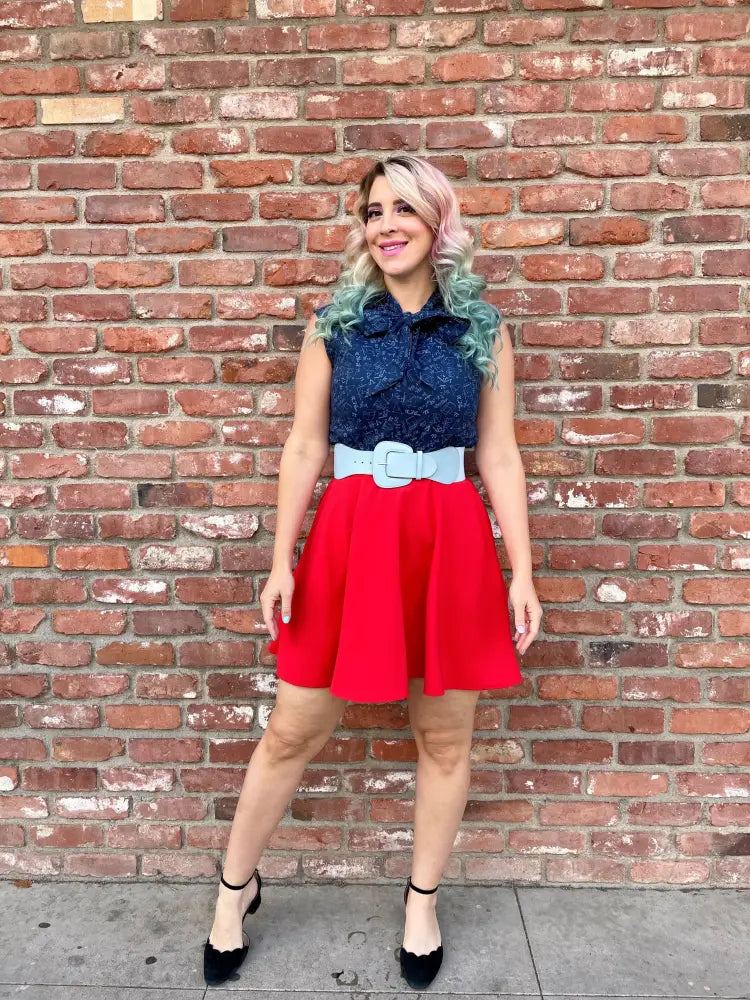 Red flared skirt with light blue belt paired with stem print navy lace bow top featuring mathematical symbols