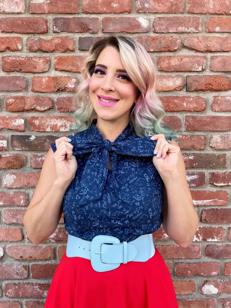 Navy lace bow top with math-themed pattern and prominent bow at neckline in stem print design