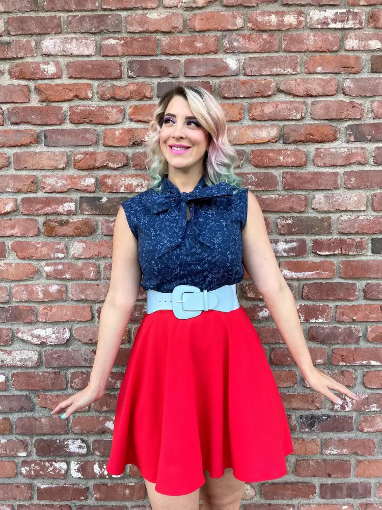 A navy blue lace sleeveless top with a bow neckline featuring a stem print and mathematical symbols design