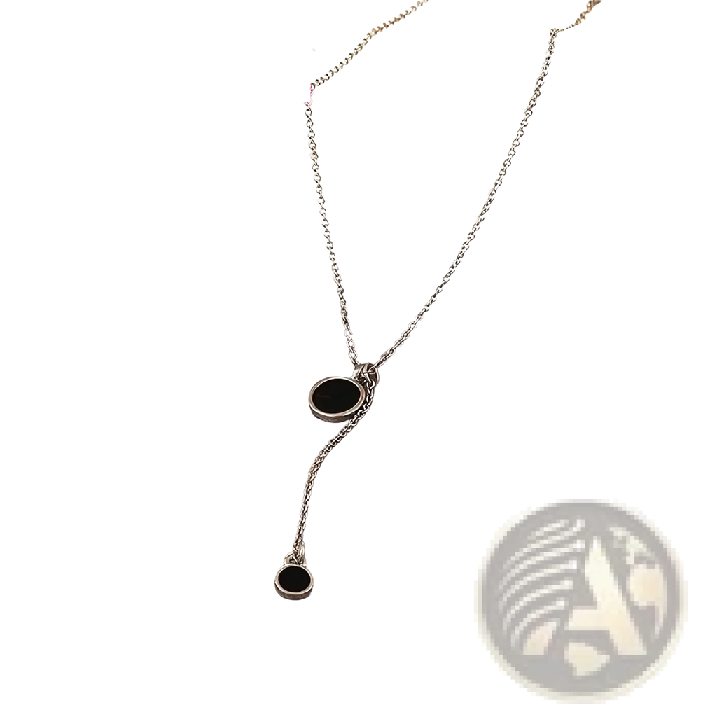 Sterling silver necklace with two black circular pendants featuring a delicate minimalist double circle design