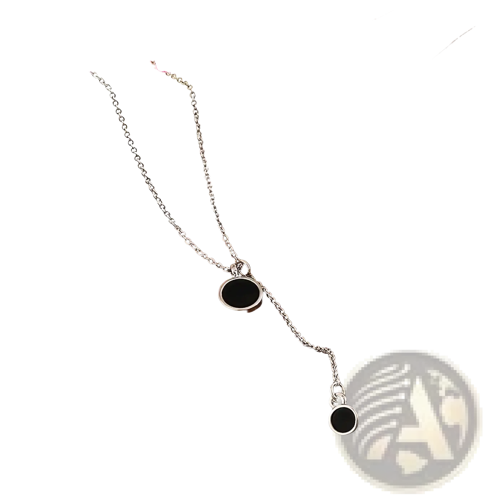 Sterling silver necklace with two black circular pendants featuring a delicate minimalist design