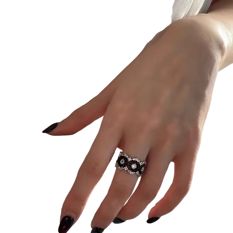 A patico sterling silver black geometric ring for women with a silver band, intricate floral pattern, and clear stones