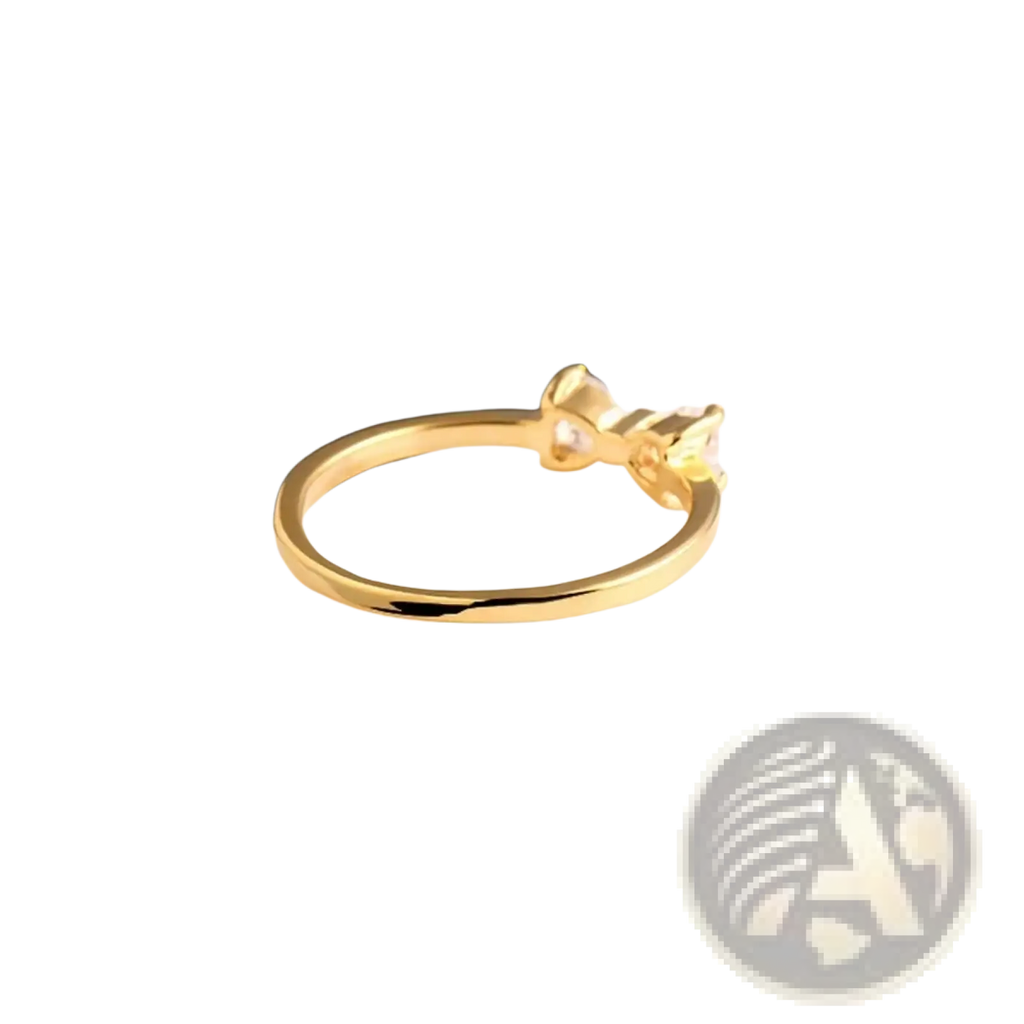 Sterling silver gold-colored bow cubic zirconia wedding band featuring a delicate bow design with a small clear gemstone