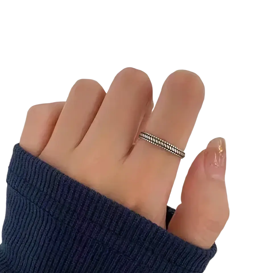 Sterling silver braided toe ring with delicate twisted design worn on a finger