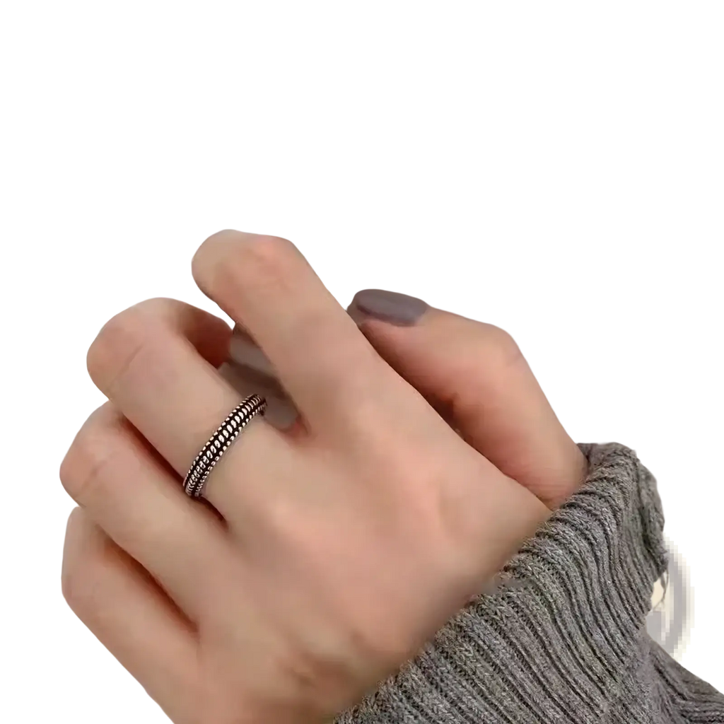 Sterling silver braided toe ring with a delicate textured design worn on a finger