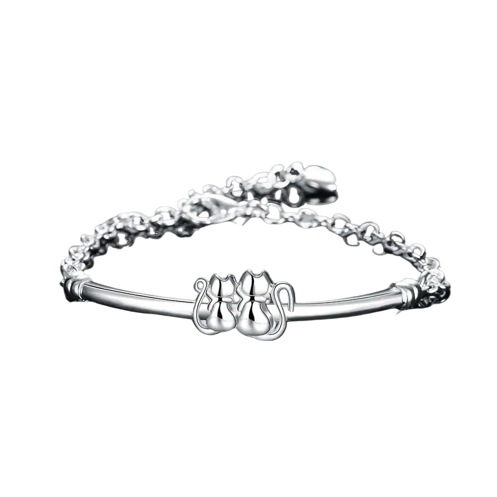 Sterling silver cat couple charm bracelet with two intricately designed cat figures on a polished chain