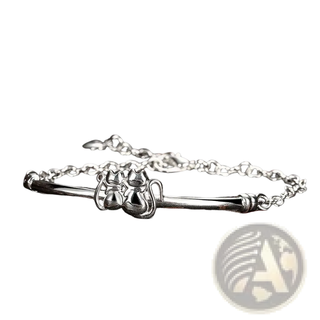 Sterling silver cat couple charm bracelet featuring a silver cat-themed bangle with delicate chain and polished finish