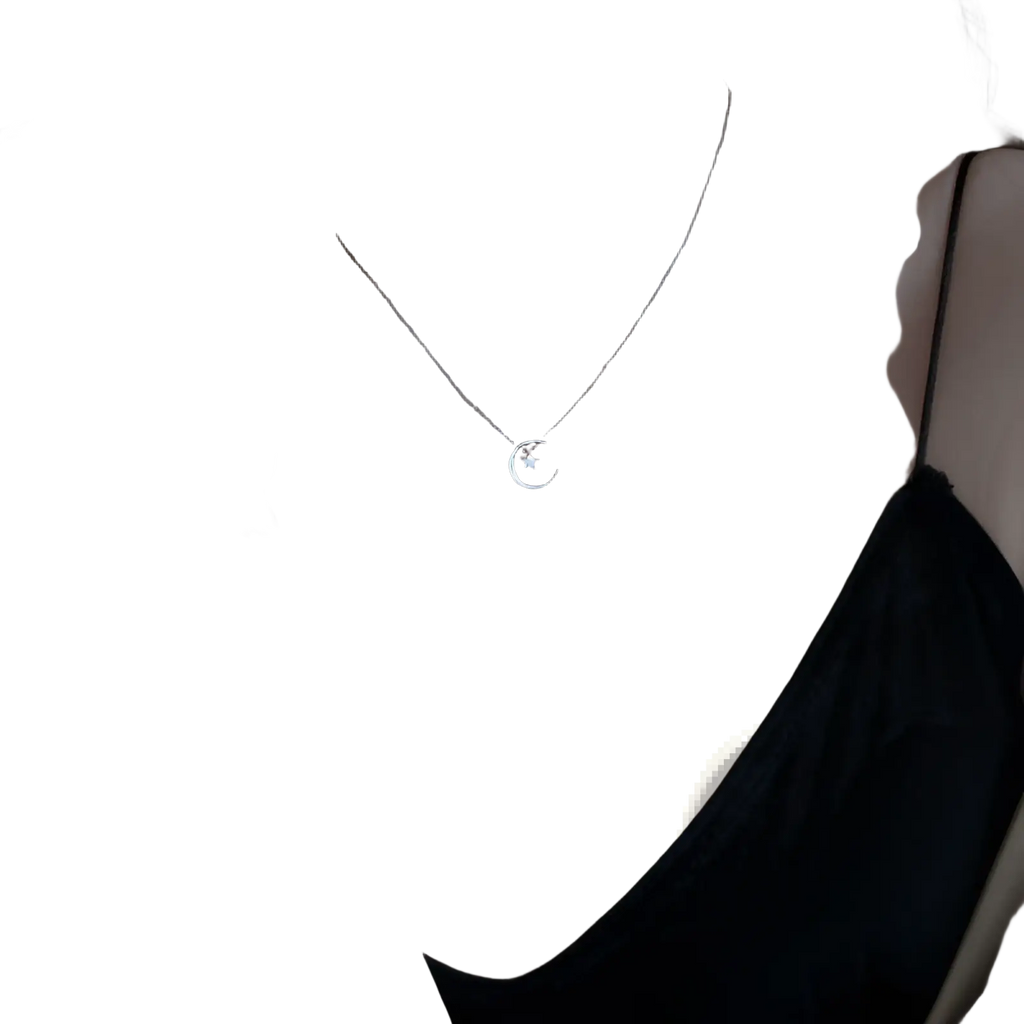 Sterling silver crescent moon and star pendant necklace featuring a delicate silver crescent with a small star center
