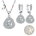 Sterling silver crystal bridal jewelry set featuring silver-toned swirling pendant and matching hoop earrings with clear crystals