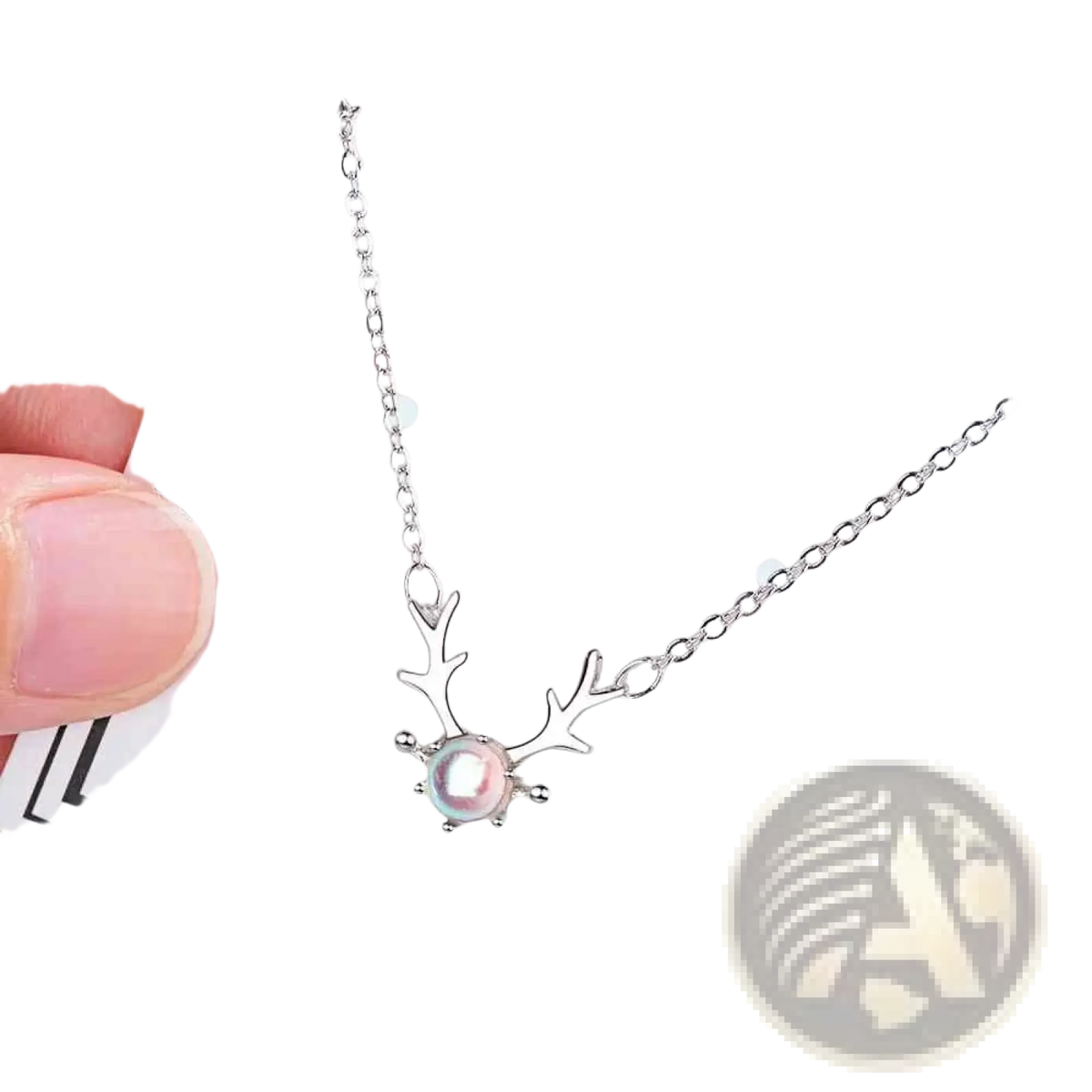 Sterling silver deer antler necklace with a central pink pearl pendant displayed on a luxury jewelry card
